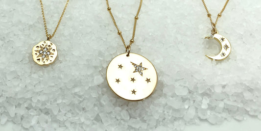 Gold charm necklaces with celestial meaning