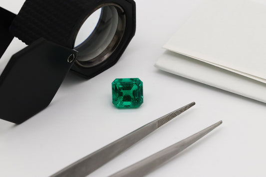 Emerald stone shown with loop and tweezers