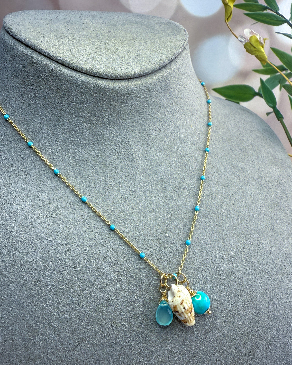 Turquoise, blue gemstone & shell charms on a beaded enamel vermeil chain.