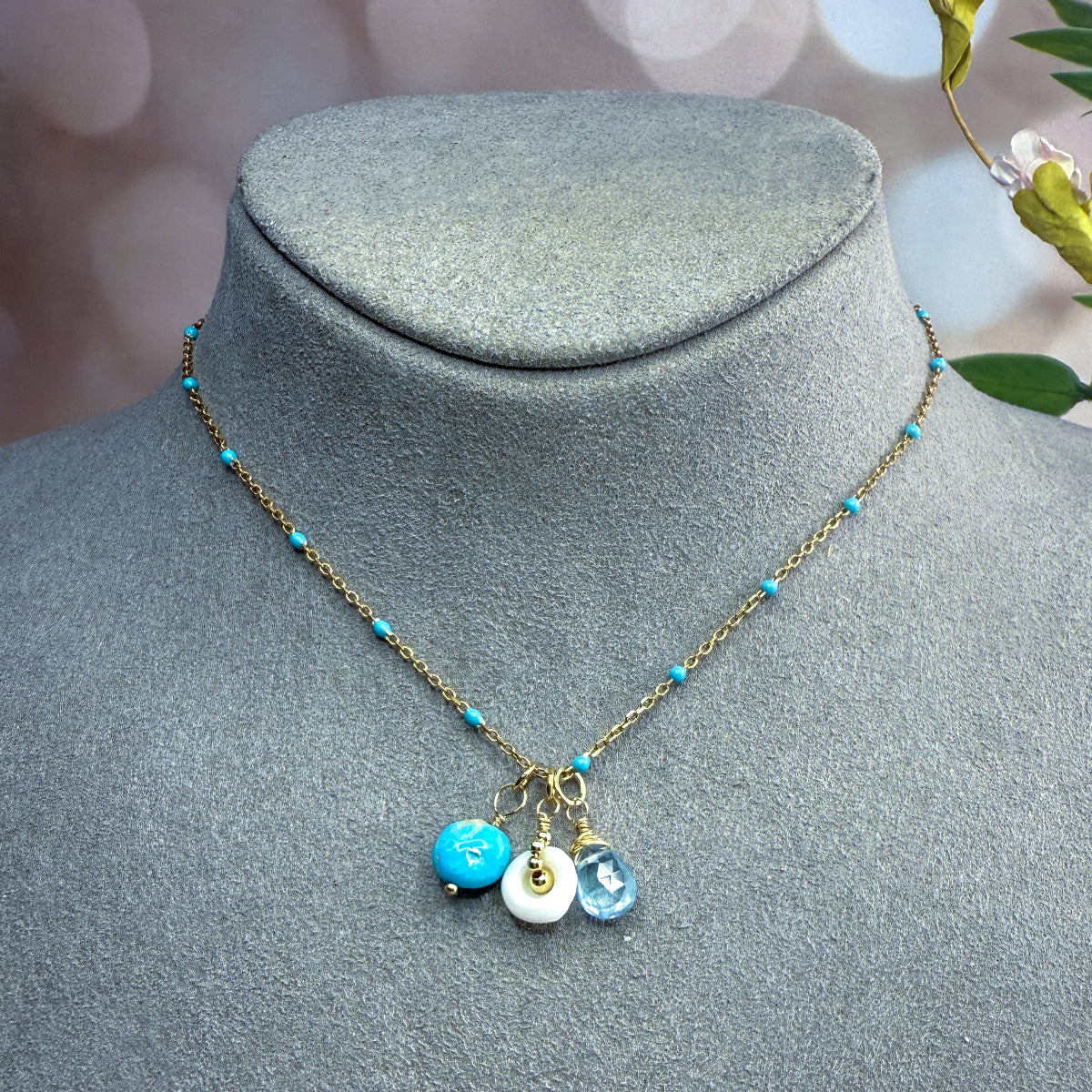 Turquoise, blue gemstone & shell charms on a beaded enamel vermeil chain.