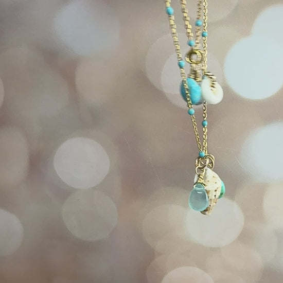 Puka, shell, turquoise & Aquamarine charms on an enamel beaded chain. 